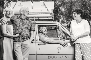 Black and white photo of founders of Dog Point with a car and 'Dog Point' branding.