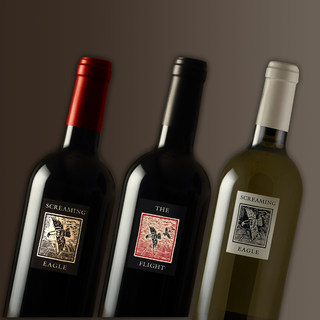 Three bottles of Screaming Eagle from Napa with labels on a brown background